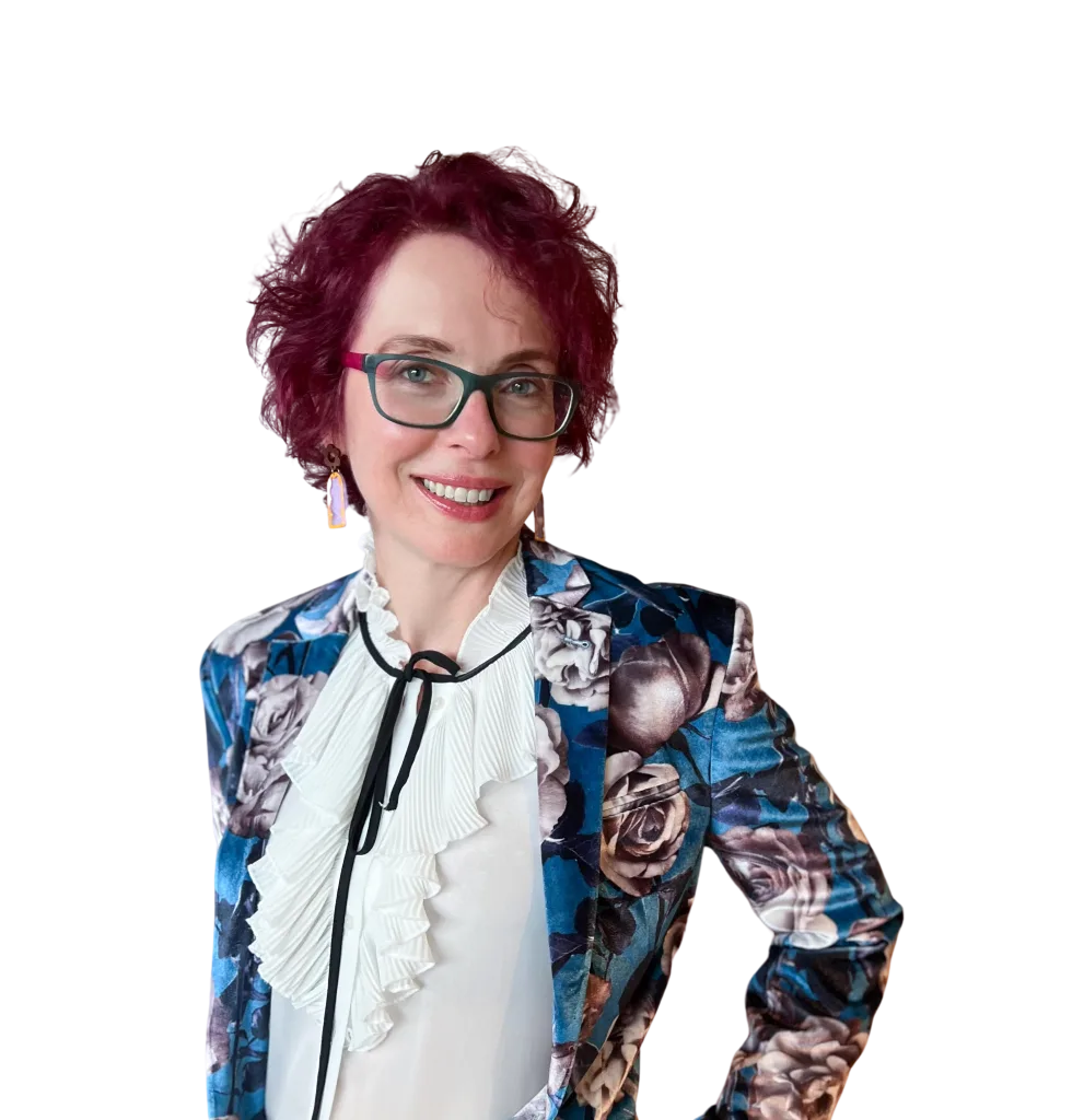 Photograph of Nat, director of Bell Training Solutions smiling and wearing a blue floral jacket